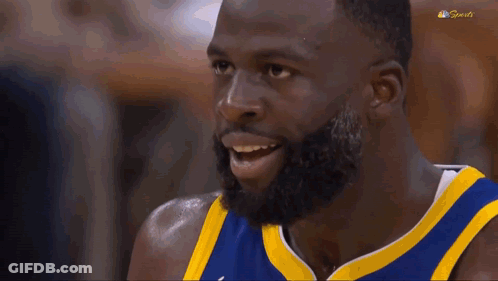 A Basketball Player With A Beard Is Making A Funny Face With His Mouth Open . GIF