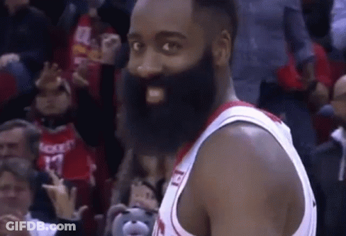 A Basketball Player With A Beard Is Standing In Front Of A Crowd Of People . GIF