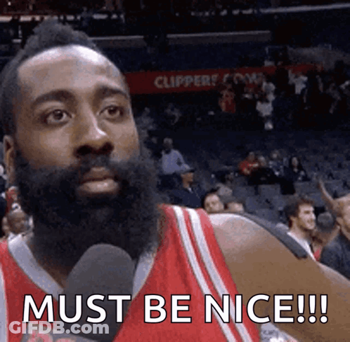 A Basketball Player With A Beard Is Talking Into A Microphone And Says Must Be Nice ! GIF