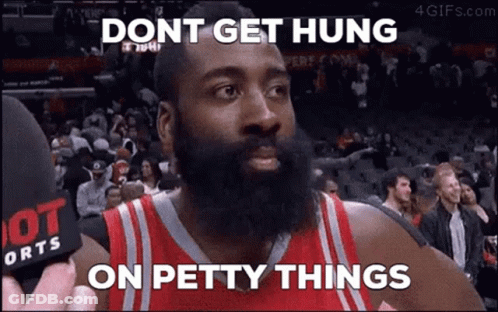 A Basketball Player With A Beard Is Talking Into A Microphone While A Crowd Watches . GIF