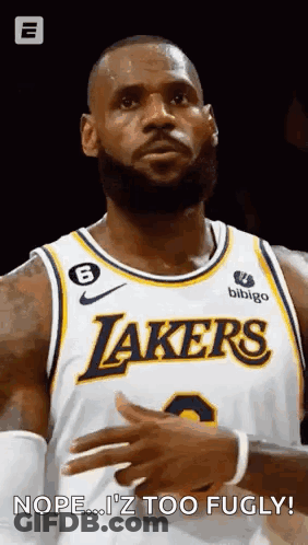 A Basketball Player With A Beard Is Wearing A Lakers Jersey And Looking At The Camera . GIF