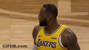 A Basketball Player With A Beard Is Wearing A Yellow Lakers Jersey . GIF