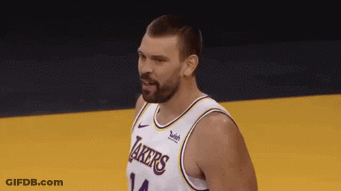 A Basketball Player With A Beard Wearing A Lakers Jersey Is Standing On A Court . GIF