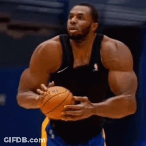 A Basketball Player With A Lot Of Muscles Is Holding A Basketball In His Hands . GIF