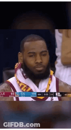 A Basketball Player With A Towel Around His Neck Is Sitting In The Stands GIF