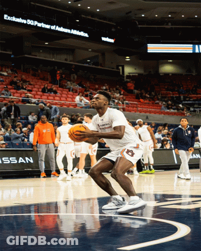 A Basketball Player With Auburn On His Shorts Holds The Ball GIF