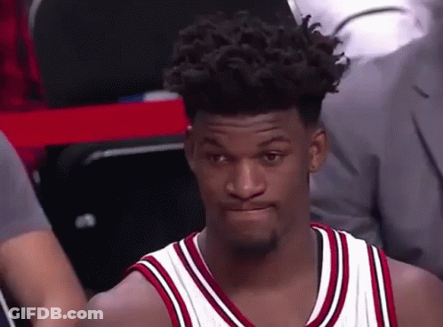 A Basketball Player With Curly Hair Is Sitting In The Stands During A Game And Making A Funny Face . GIF