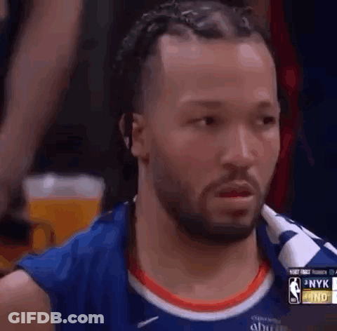 A Basketball Player With Dreadlocks And A Beard Is Looking At Something . GIF