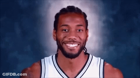 A Basketball Player With Dreadlocks And A Beard Smiles For The Camera . GIF