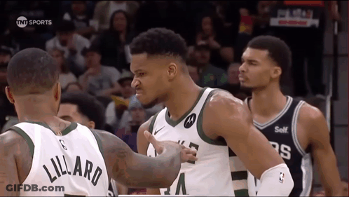 A Basketball Player With The Name Lillard On His Back GIF