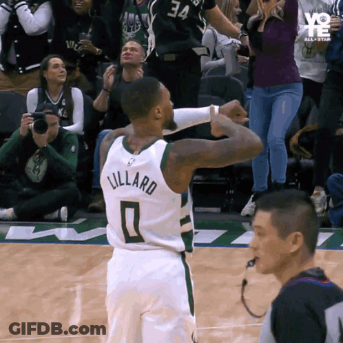 A Basketball Player With The Name Lillard On His Jersey Stands On The Court GIF