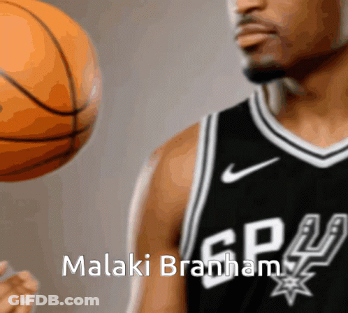 A Basketball Player With The Name Malaki Branham On His Shirt GIF