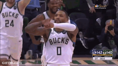 A Basketball Player With The Number 0 On His Jersey Is Giving A High Five To Another Player . GIF