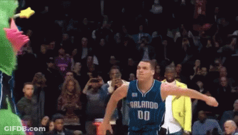 A Basketball Player With The Number 00 On His Jersey Is Jumping In The Air GIF