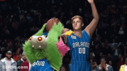 A Basketball Player With The Number 00 On His Jersey Stands Next To A Mascot GIF