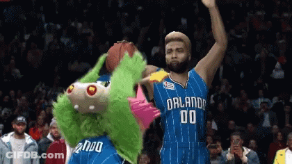 A Basketball Player With The Number 00 On His Jersey Stands Next To A Mascot GIF