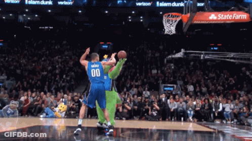A Basketball Player With The Number 00 On His Jersey Tries To Dunk The Ball GIF