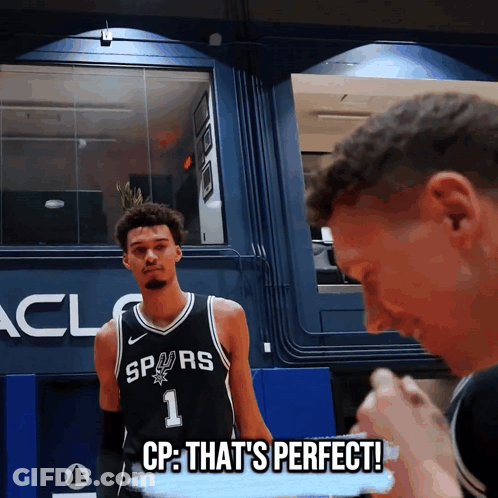 A Basketball Player With The Number 1 On His Jersey Is Standing Next To Another Player GIF