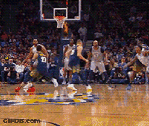 A Basketball Player With The Number 10 On His Back Is Dribbling The Ball GIF