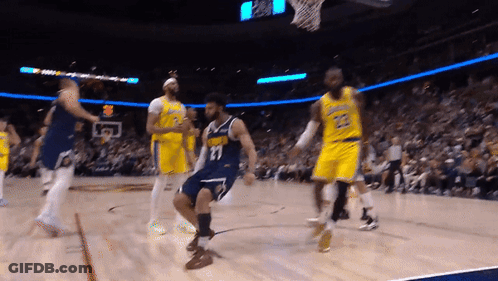 A Basketball Player With The Number 11 On His Jersey Is Dancing On The Court GIF