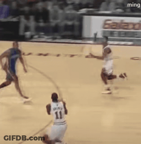 A Basketball Player With The Number 11 On His Jersey Is Dribbling The Ball GIF