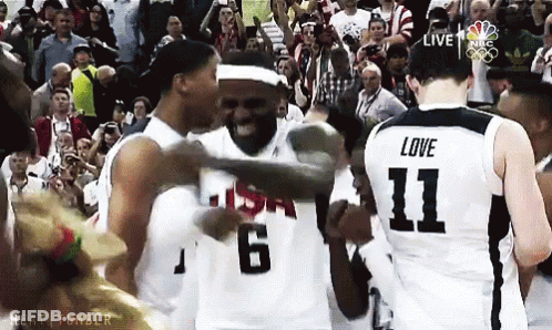 A Basketball Player With The Number 11 On His Jersey Is Hugging Another Player GIF