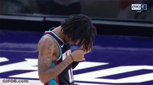 A Basketball Player With The Number 11 On His Jersey Looks Down GIF