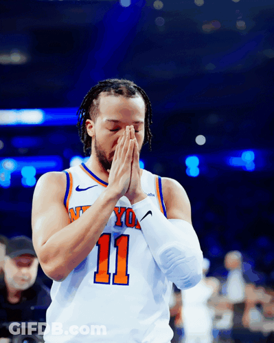 A Basketball Player With The Number 11 On His Jersey Praying GIF