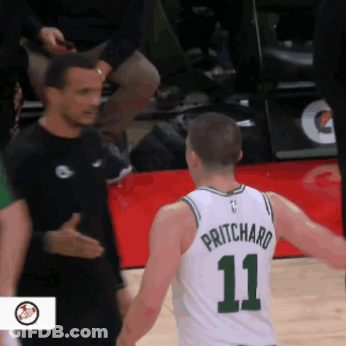 A Basketball Player With The Number 11 On His Jersey Talks To Another Player GIF