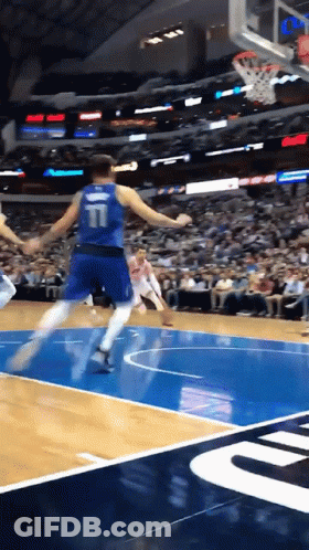 A Basketball Player With The Number 11 On The Back Of His Jersey Is Jumping In The Air GIF