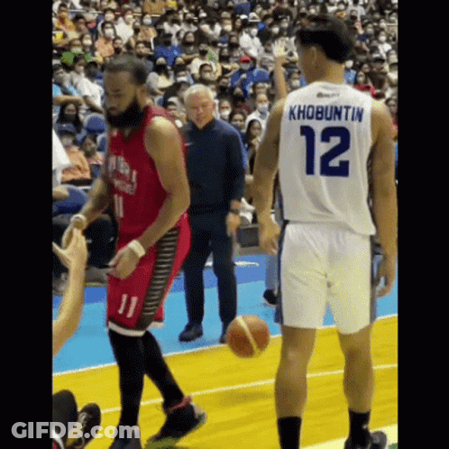 A Basketball Player With The Number 12 On His Back Is Talking To Another Player GIF