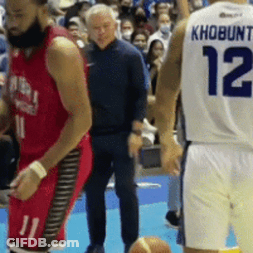 A Basketball Player With The Number 12 On His Back Stands Next To Another Player GIF