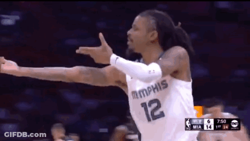 A Basketball Player With The Number 12 On His Jersey Is Celebrating GIF