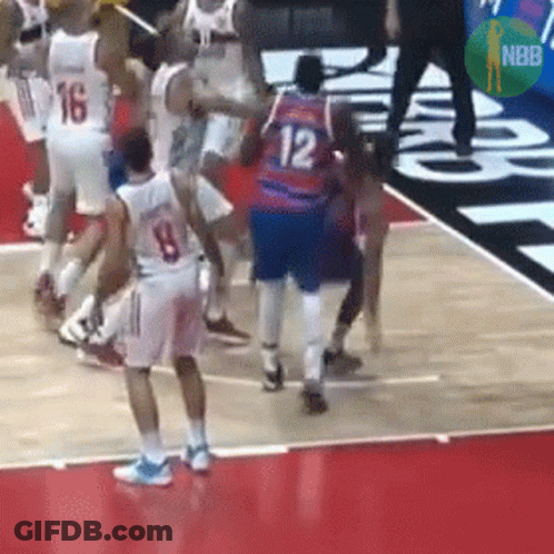 A Basketball Player With The Number 12 On His Jersey Is Surrounded By Other Players On The Court . GIF
