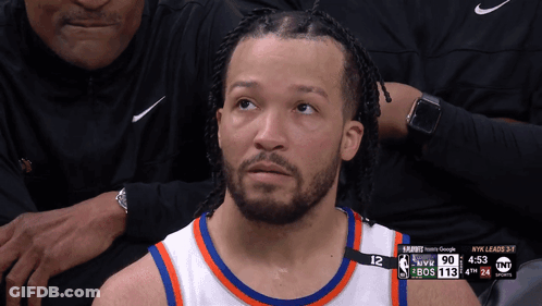 A Basketball Player With The Number 12 On His Jersey Looks Up At The Sky GIF