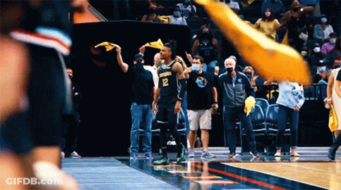 A Basketball Player With The Number 12 On His Jersey Stands On The Court GIF