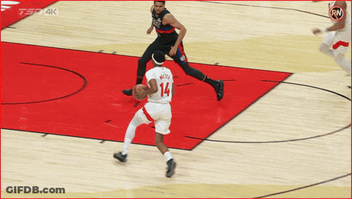 A Basketball Player With The Number 14 On His Jersey Dribbles The Ball GIF