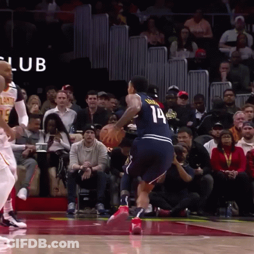 A Basketball Player With The Number 14 On His Jersey Is Dribbling The Ball GIF
