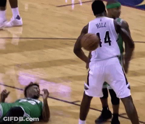 A Basketball Player With The Number 14 On His Jersey Is Holding A Basketball GIF