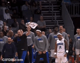A Basketball Player With The Number 14 On His Jersey Stands In Front Of His Teammates GIF