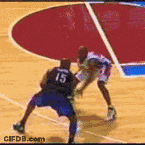 A Basketball Player With The Number 15 On His Back Tries To Block Another Player GIF