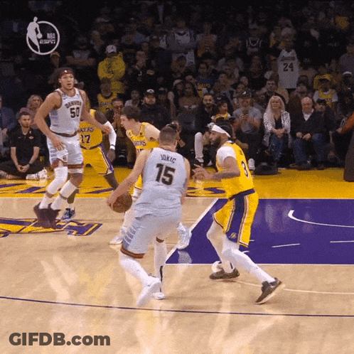 A Basketball Player With The Number 15 On His Jersey Dribbles The Ball GIF