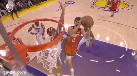 A Basketball Player With The Number 15 On His Jersey Goes For A Layup GIF