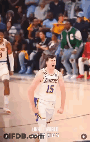 A Basketball Player With The Number 15 On His Jersey Is Celebrating On The Court During A Game . GIF