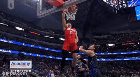 A Basketball Player With The Number 15 On His Jersey Jumps Up To Throw The Ball GIF