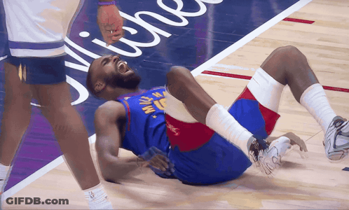 A Basketball Player With The Number 15 On His Jersey Lays On The Floor GIF