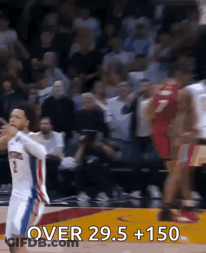 A Basketball Player With The Number 2 On His Jersey Is Jumping For A Rebound GIF