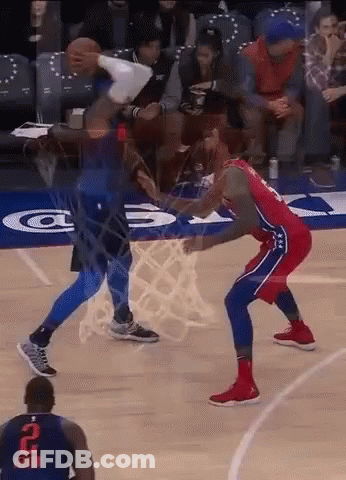 A Basketball Player With The Number 2 On His Jersey Is Trying To Block Another Player 'S Shot . GIF