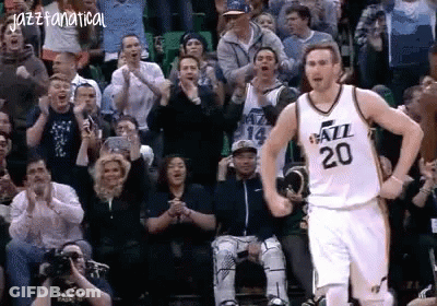A Basketball Player With The Number 20 On His Jersey Stands In Front Of A Crowd . GIF