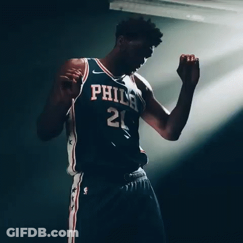 A Basketball Player With The Number 21 On His Jersey Is Dancing GIF
